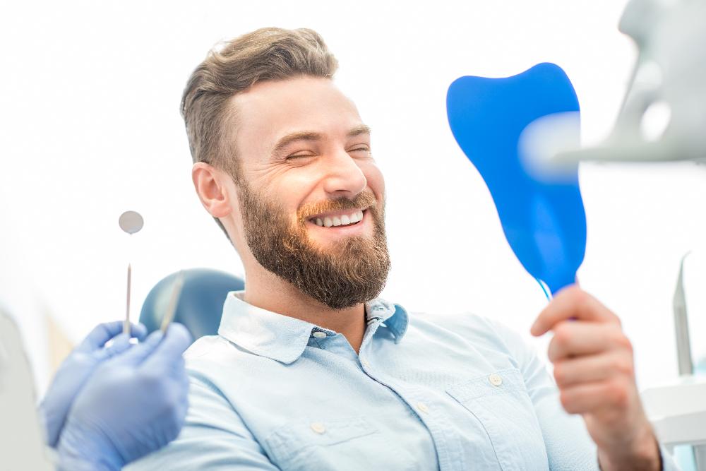 Man smiling in mirror in dental chair, pascoe vale vic