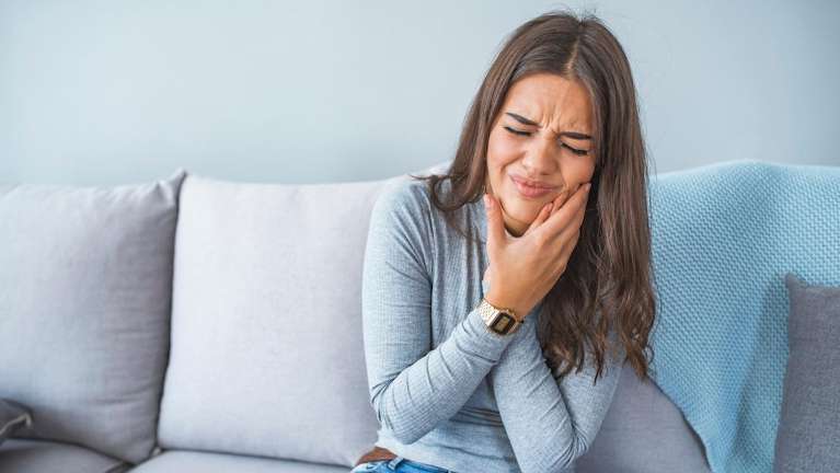 Young woman holding her jaw in pain, pascoe vale vic