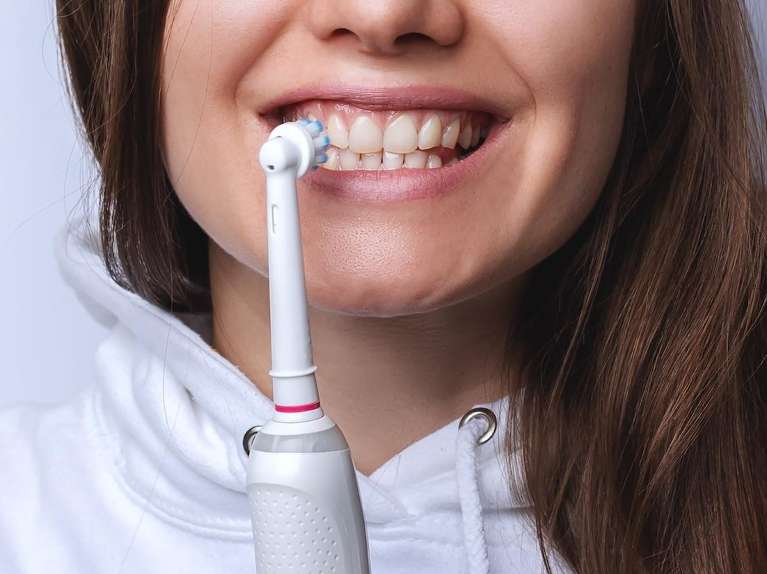 An electric toothbrush on a smiling mouth, pascoe vale vic