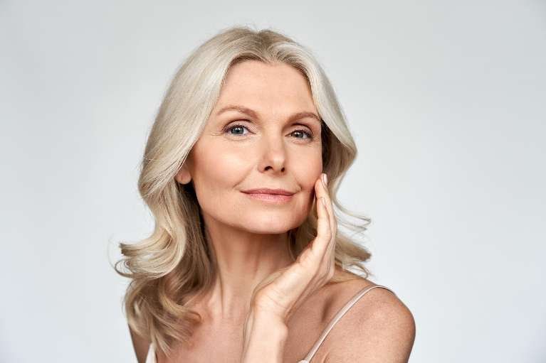 Older woman holding her hand against her face after botox, pascoe vale vic