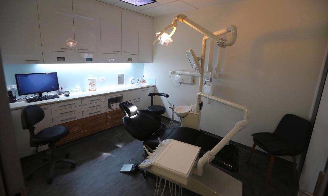 one of our pascoe vale patient care rooms featuring a desk, dental chair, and various dental tools