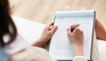 Lumino Smiles Dental | Forms | Patient filling out paperwork